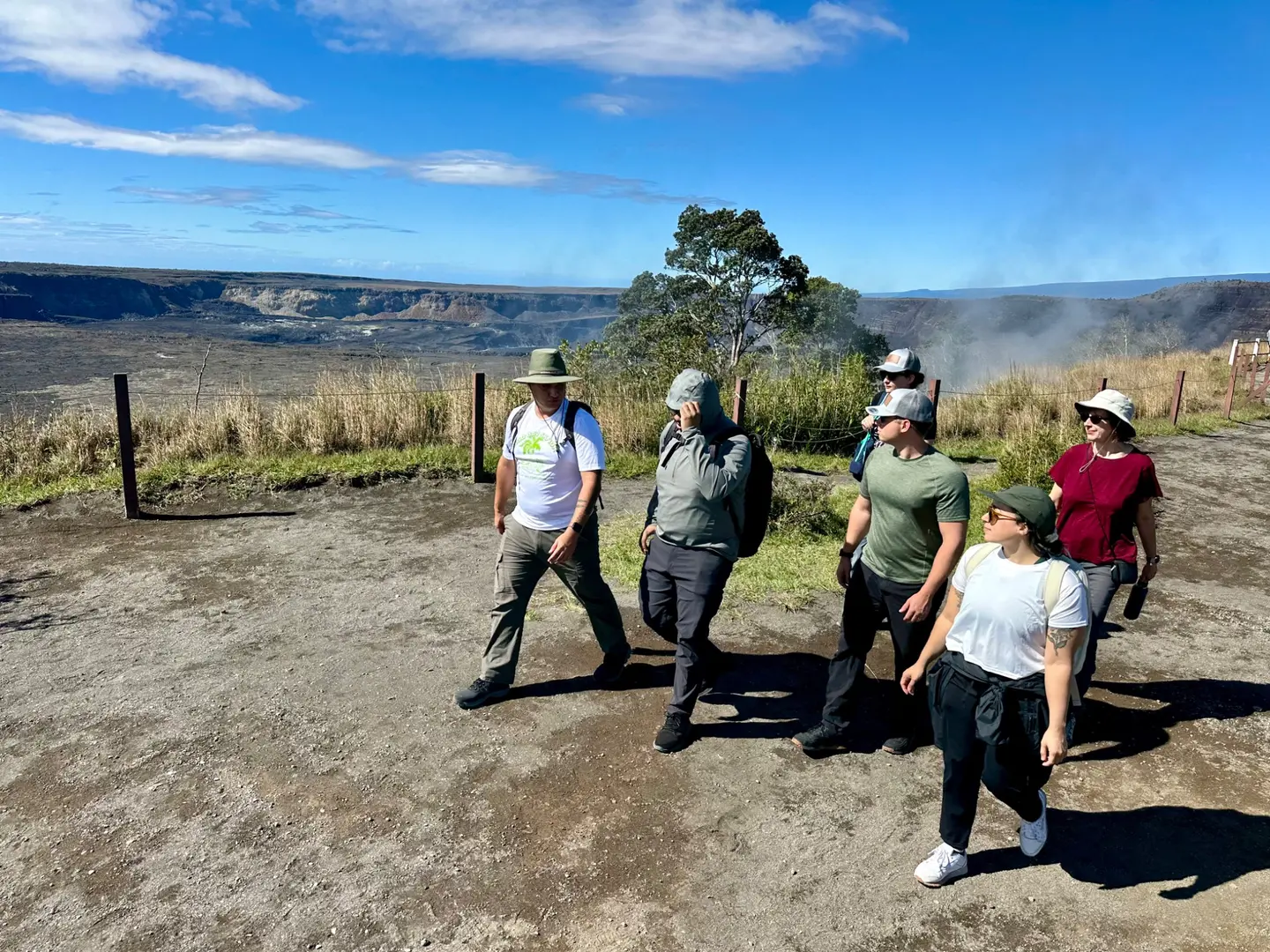 A field team walking together through a volcanic landscape in Hawaiʻi